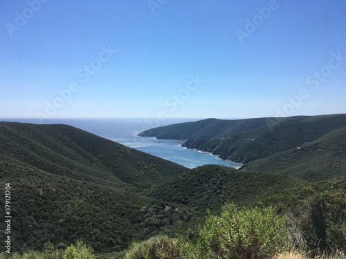 Mountain landscape on sunny summer day with clear sky in Greece with sea gulf on background