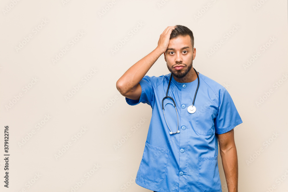 Young south-asian nurse man being shocked, she has remembered important meeting. Young south-asian nurse man being shocked, she has remembered important meeting.