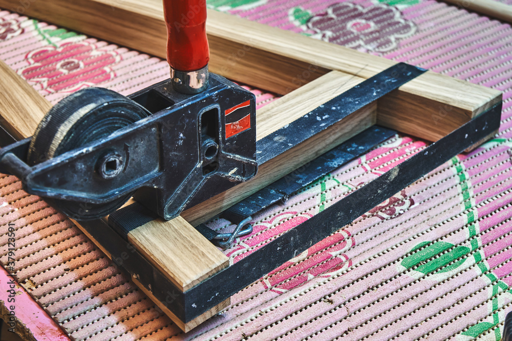 Joinery. Gluing and clamping wooden table leg. Wooden furniture