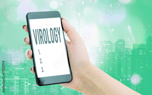 Writing note showing Virology. Business concept for branch of science dealing with the variety of viral agents and disease Modern gadgets white screen under colorful bokeh background photo