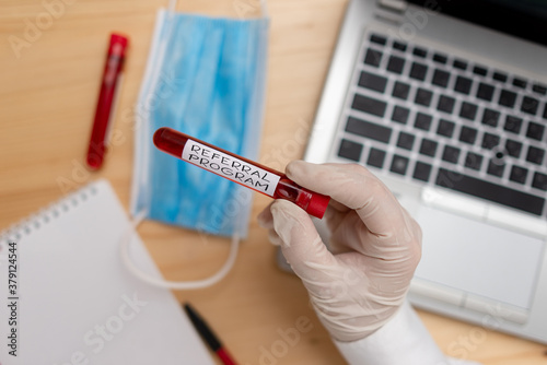 Handwriting text writing Referral Program. Conceptual photo employees are rewarded for introducing suitable recruits Extracted blood sample vial with lastest technology ready for examination photo
