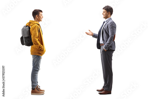 Full length profile shot of a male teenager listening to his father talking