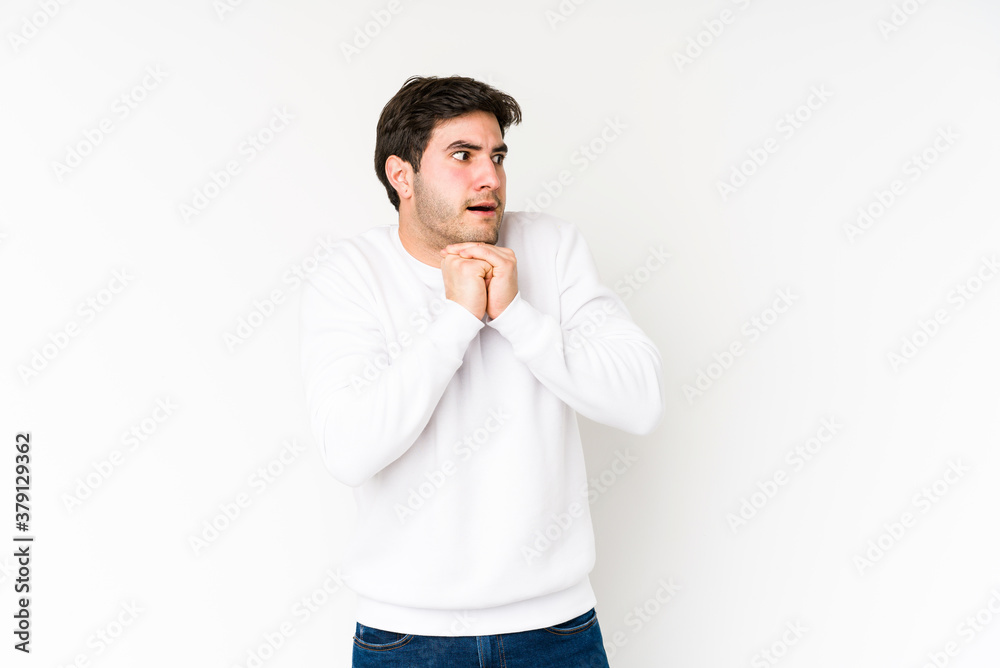 Young man isolated on white background praying for luck, amazed and opening mouth looking to front. Young man isolated on white background praying for luck, amazed and opening mouth looking to front.