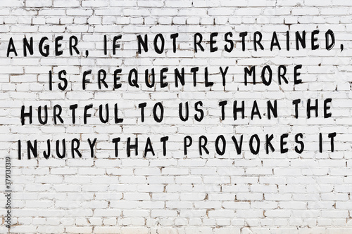 Tableau sur toile White brick wall with painted black inscription of wise quote
