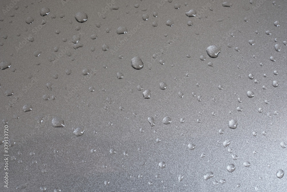 Water droplets on a gray painted steel background Water droplets on a gray painted steel background