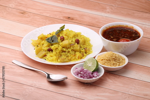 Aloo/Kanda Poha or Tarri Pohe with spicy chana masala/curry. Served in ceramic plate. photo