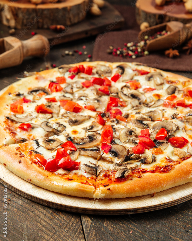Closeup on pizza with mushrooms and tomatoes