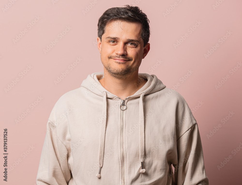 Fototapeta premium White guy in hoodie on pink background