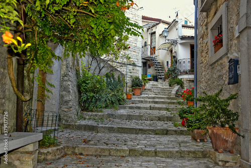 Fototapeta Naklejka Na Ścianę i Meble -  A narrow street among the old houses of San Marco dei Cavoti, a small town in the province of Benevento, Italy.