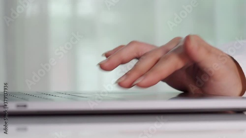 close-up female hand touching touchpad on a laptop computer