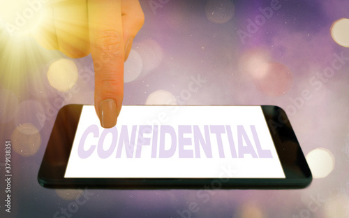 Conceptual hand writing showing Confidential. Concept meaning containing an individualal information whose unauthorized disclosure Modern gadgets white screen under colorful bokeh background photo