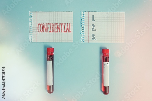 Writing note showing Confidential. Business concept for containing an individualal information whose unauthorized disclosure Blood sample vial medical accessories ready for examination photo