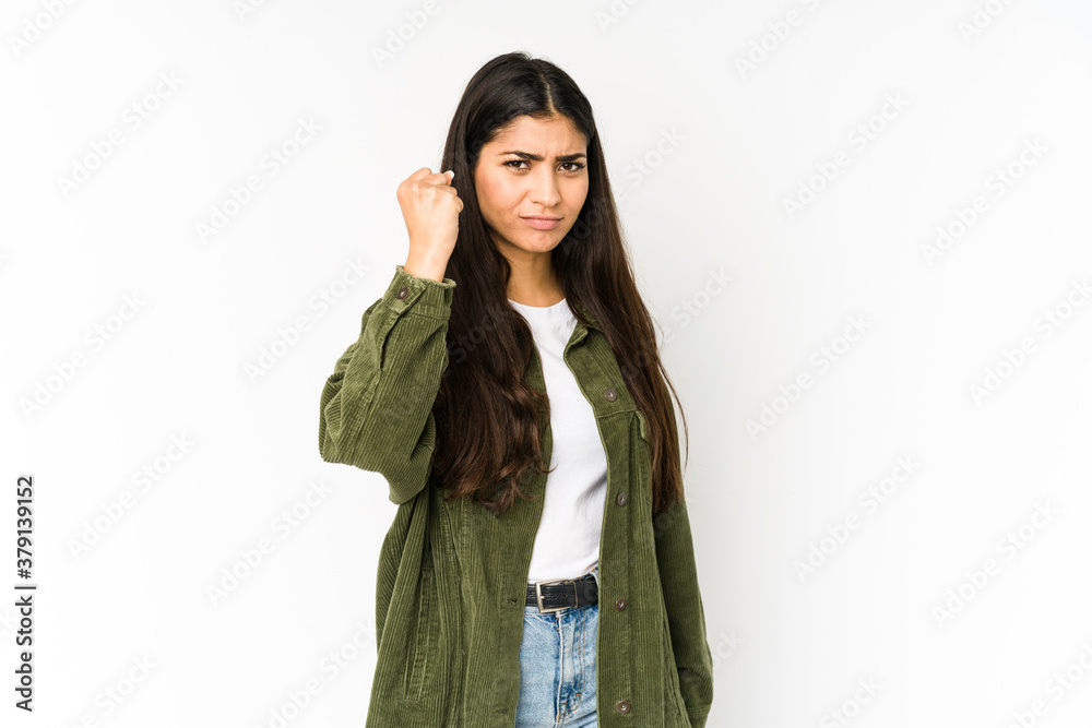 Young indian woman isolated on purple background showing fist to camera, aggressive facial expression. Young indian woman isolated on purple background showing fist to camera, aggressive facial expression.