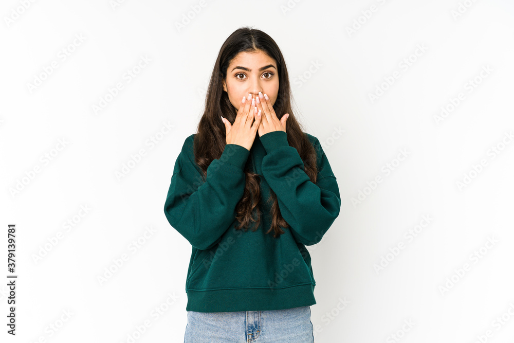 Young indian woman isolated on purple background shocked covering mouth with hands. Young indian woman isolated on purple background shocked covering mouth with hands.