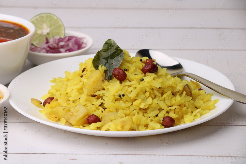 Aloo/Kanda Poha or Pohe with onion. Served in ceramic plate.