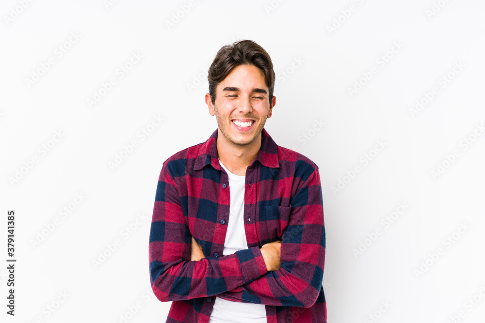 Young caucasian man posing in a pink background isolated laughing and having fun. Young caucasian man posing in a pink background isolated laughing and having fun.