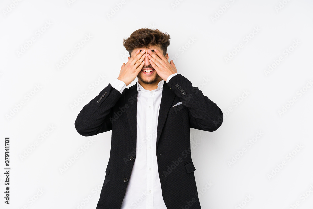 Young arabian business man isolated covers eyes with hands, smiles broadly waiting for a surprise. Young arabian business man isolated covers eyes with hands, smiles broadly waiting for a surprise.