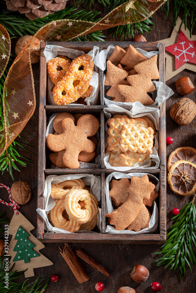 Fototapeta premium Sweet gingerbread cookies for Christmas decorated with spruce and nuts