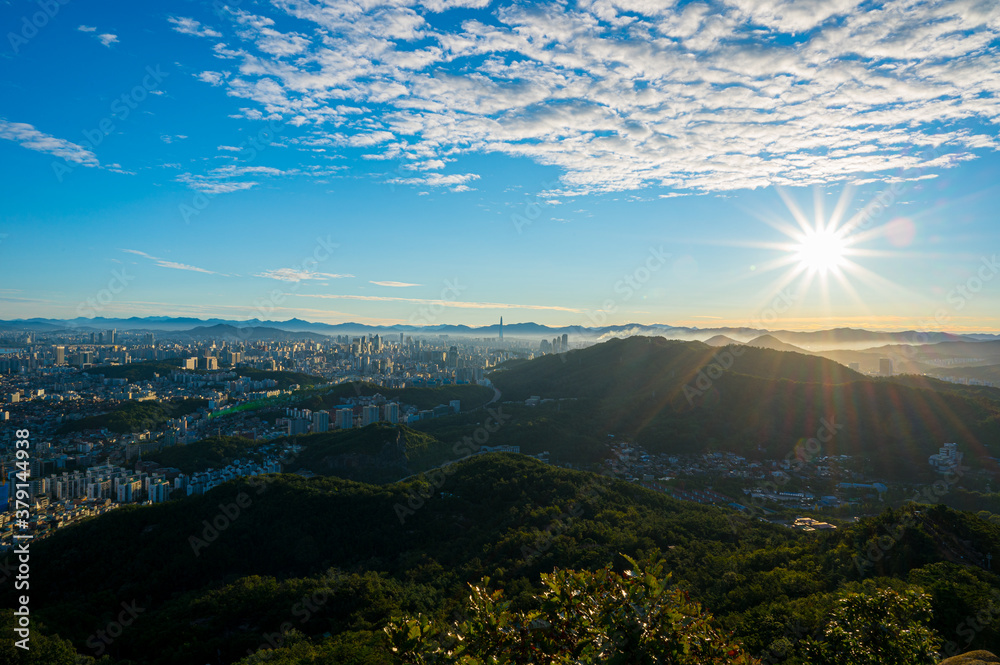 Landscape of Seoul South Korea on the day and the sun shines on the city.And blue sky and white clouds