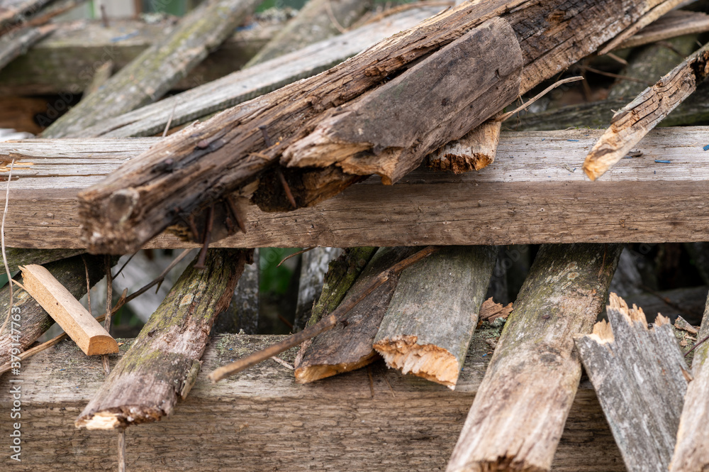 A pile of old boards suitable for the furnace, close-up, selective focus.