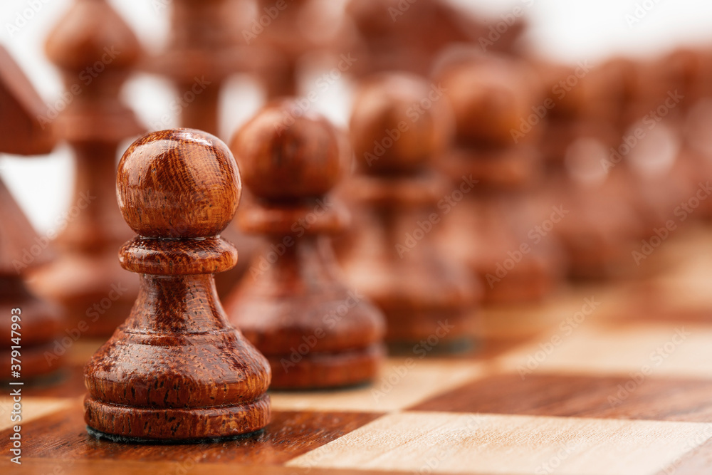 wooden chessboard with pieces and pawns in light and dark brown tones, isolate on a white background wooden chessboard with pieces and pawns in light and dark brown tones, isolate on a white background