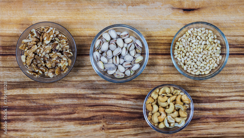 bowls with nuts on wooden background bowls with nuts on wooden background