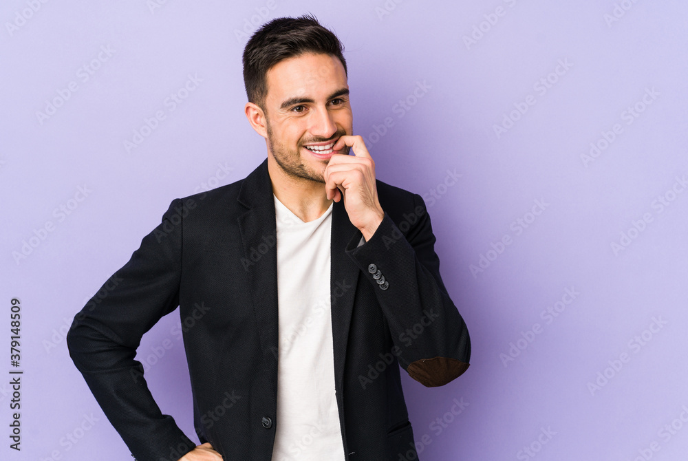 Young caucasian man isolated on purple background relaxed thinking about something looking at a copy space. Young caucasian man isolated on purple background relaxed thinking about something looking at a copy space.