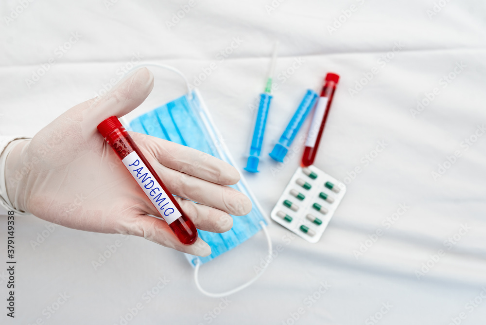 Word writing text Pandemic. Business photo showcasing occurring over a wide area affecting high proportion of population Extracted blood sample vial ready for medical diagnostic examination