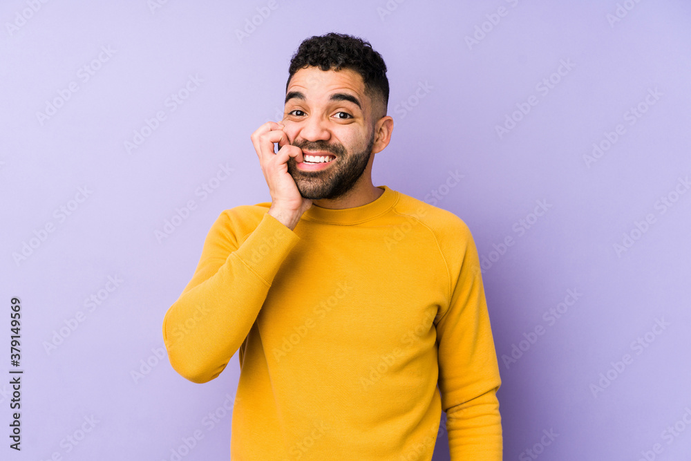 Young mixed race arabic man isolated biting fingernails, nervous and very anxious. Young mixed race arabic man isolated biting fingernails, nervous and very anxious.