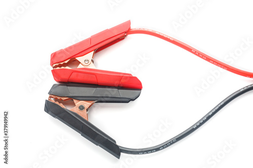 Red and black cooper jumper cable isolated on white background. Power supply wire for car battery. Top view.