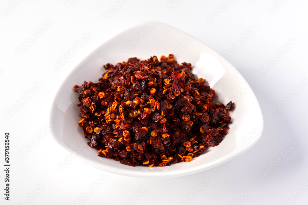 Cayenne pepper in white ceramic cup Cayenne pepper in white ceramic cup