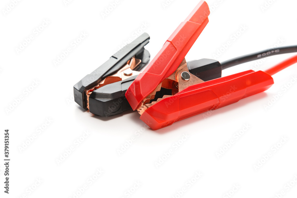 Red and black cooper jumper cable isolated on white background. Power supply wire for car battery. Red and black cooper jumper cable isolated on white background. Power supply wire for car battery.