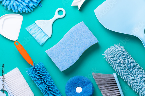 House cleaning product on green table background, housework and housekeeping concept