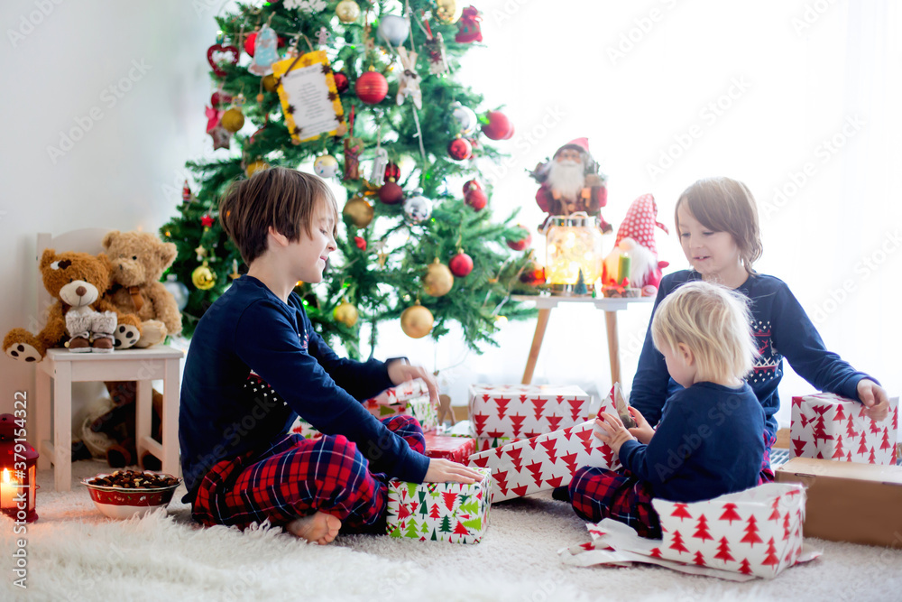 Happy children, opening presents on christmas day Happy children, opening presents on christmas day