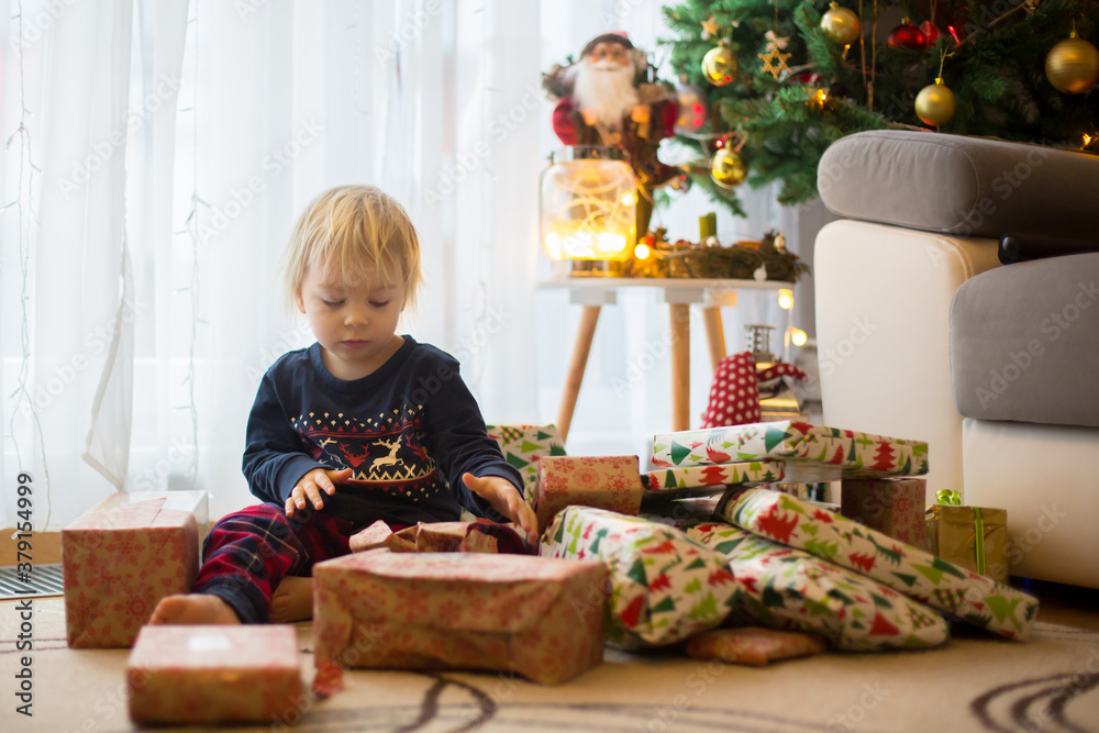 Happy child, opening presents on christmas day Happy child, opening presents on christmas day