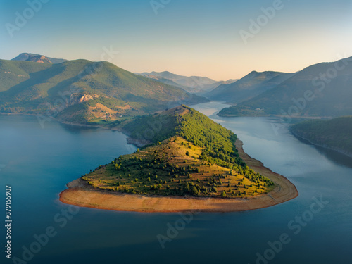 The river Arda valley in Rhodope mountains in Bulgaria during sunset. Meanders in the Lake Kardzhali or Kardjali photo