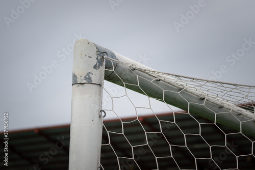 Football (soccer) goal and crossbar structure in standard stadium, object close-up.