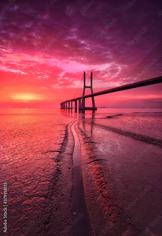 bridge over the river at the red sunrise