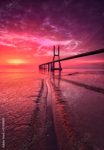 bridge over the river at the red sunrise © Alberto