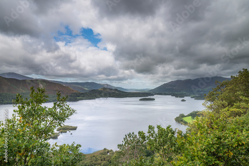 Beautiful moody landscape image of view from Surprise View viewpoint in the Lake District overlooking Derwentwater with Skiddaw and Grisedale Pike in the distance