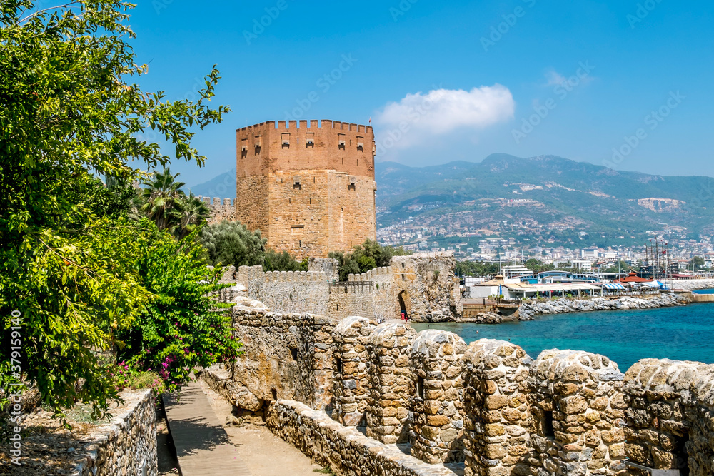 View of the walls of the ancient fortress and the tower of Kyzyl Kule in Alanya in Turkey