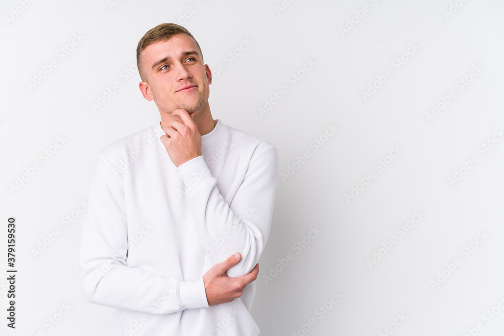 Young caucasian man on white background looking sideways with doubtful and skeptical expression. Young caucasian man on white background looking sideways with doubtful and skeptical expression.