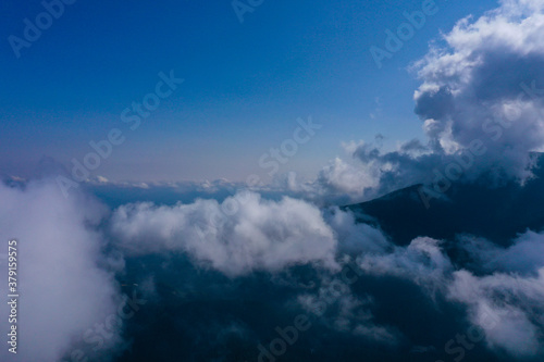 Amazing mountain cloudy view of mountains pecks. Inside the cloud, drone flight.