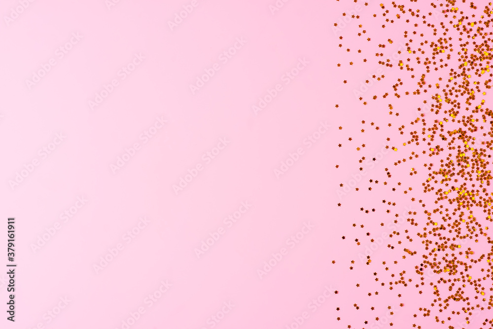 Golden confetti on pink background. Christmas, winter, new year texture. Flat lay, top view, copy space Golden confetti on pink background. Christmas, winter, new year texture. Flat lay, top view, copy space