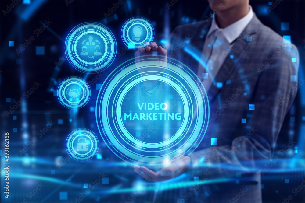 Obraz premium Business, Technology, Internet and network concept. Young businessman working on a virtual screen of the future and sees the inscription: Video marketing