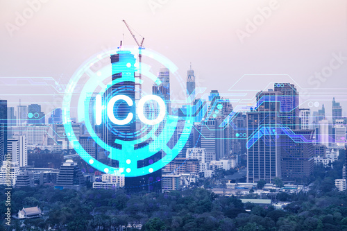ICO icon hologram over panorama city view of Bangkok, the hub of blockchain projects in Asia. The concept of initial coin offering. Double exposure.