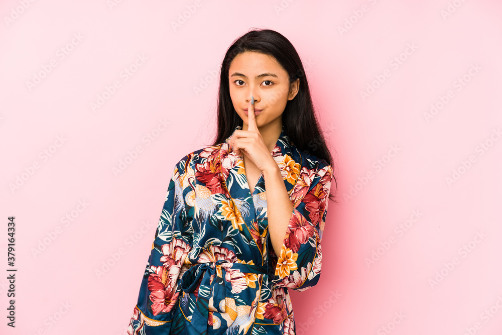 Young chinese woman wearing a asiatic pijama isolated showing number two with fingers.