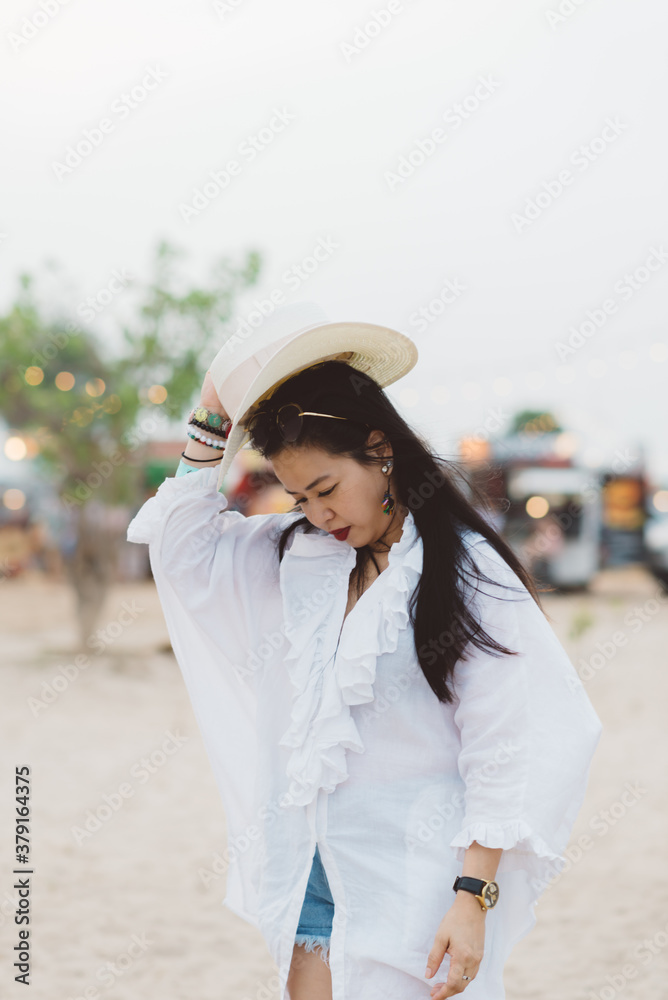 Lifestyle series: Asian woman grabbing her hat