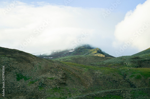 fog rises up the mountainside