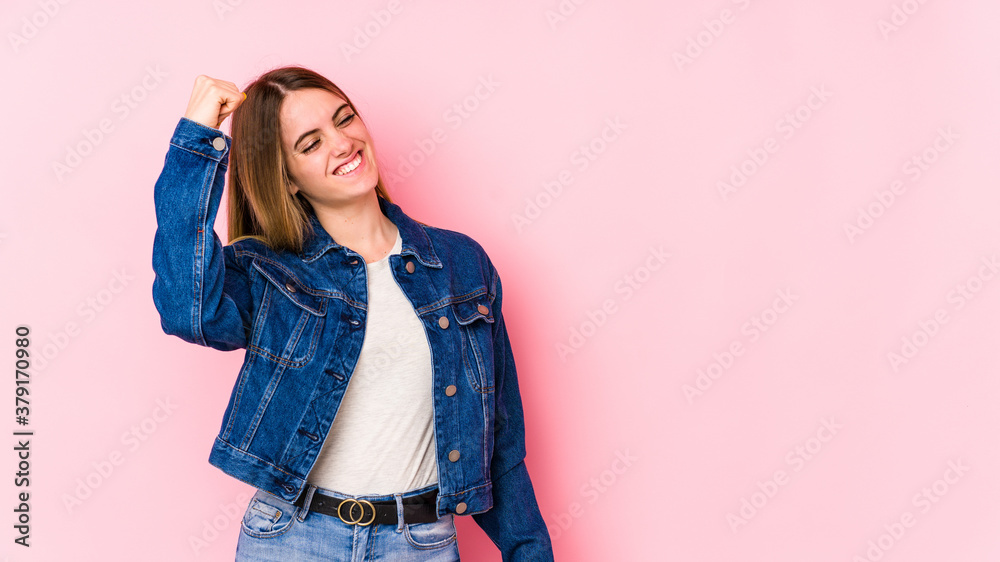 Young caucasian woman isolated on pink background celebrating a victory, passion and enthusiasm, happy expression. Young caucasian woman isolated on pink background celebrating a victory, passion and enthusiasm, happy expression.